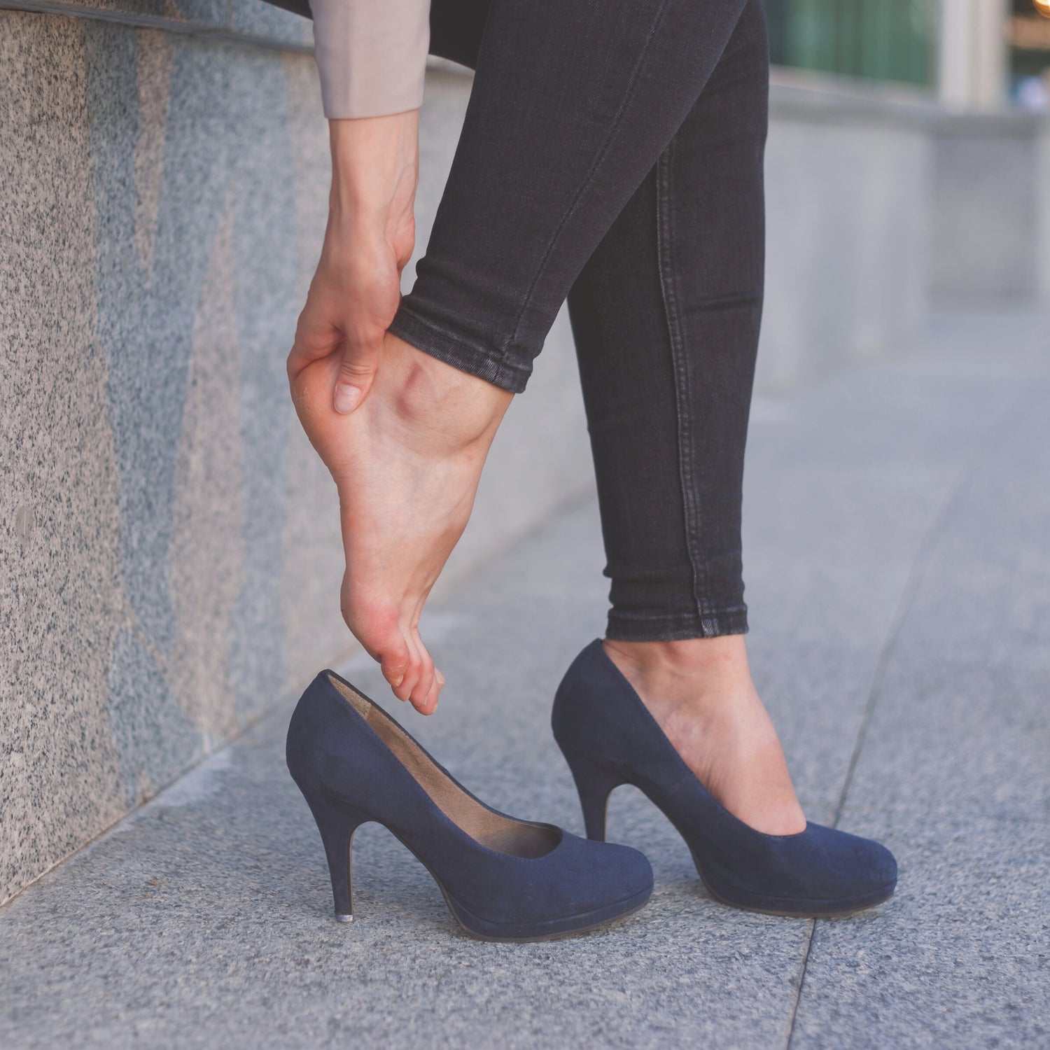 Woman having high heel pain – Heel Friend high heel inserts provide pain-free comfort.